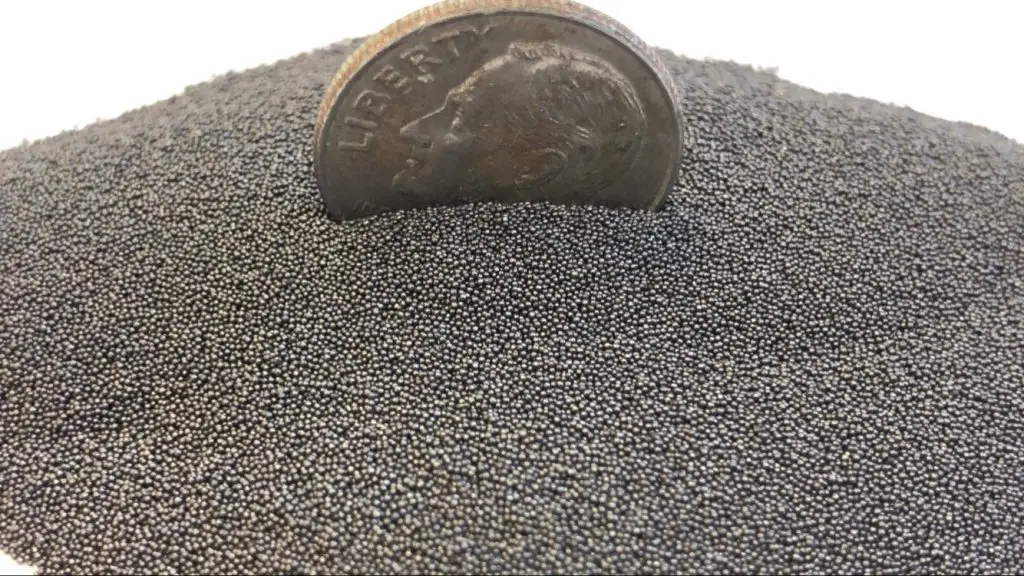 Steel shot shown with dime to indicate shot size